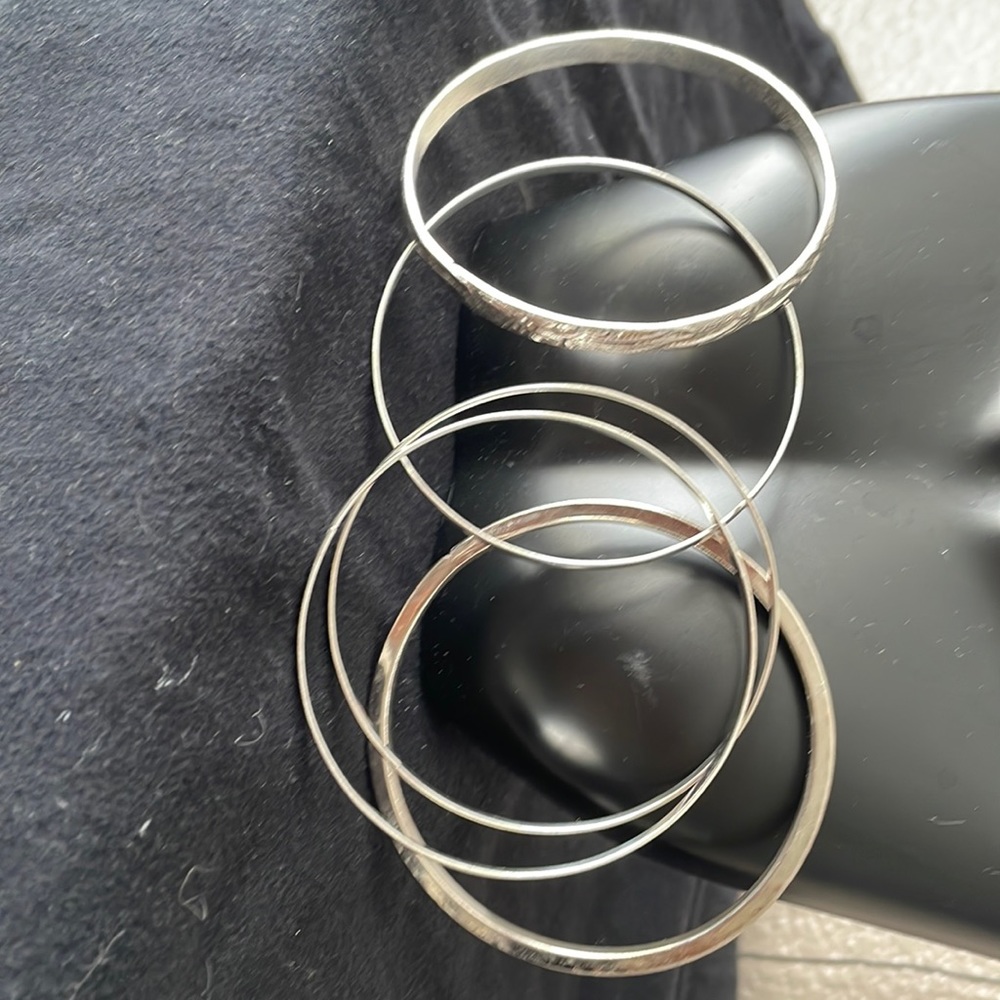 Set of 5 silver bangles.